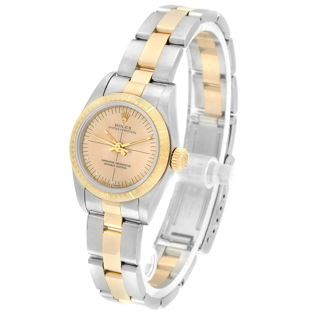 The Rolex Oyster Perpetual 67243 Women's Steel and Gold (two tone) Champagne Dial 67243 Women's Steel and Gold (two tone) Champagne Dial watch is shown at a slight angle, highlighting the face, bezel, crown, and two-tone bracelet.