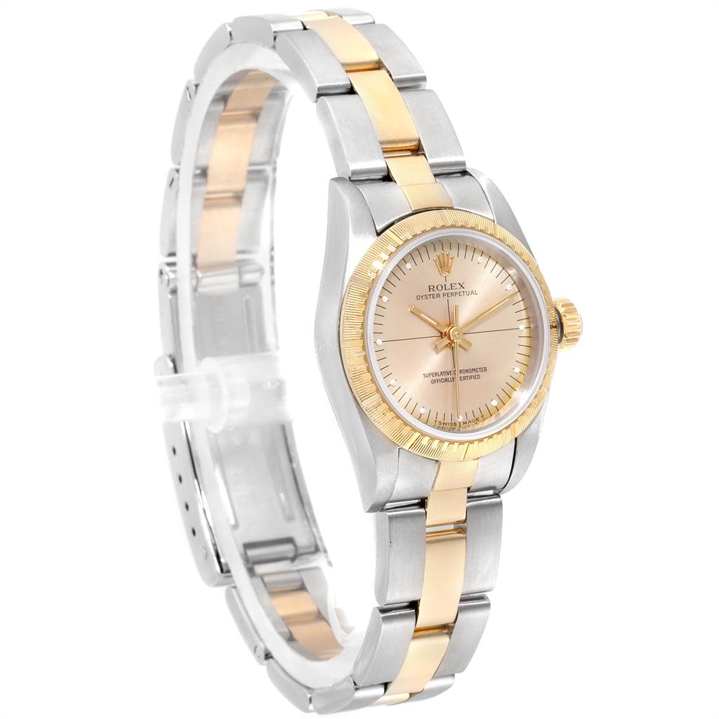 The image shows a gold and silver Rolex Oyster Perpetual 67243 Women's Steel and Gold (two tone) Champagne Dial 67243 Women's Steel and Gold (two tone) Champagne Dial watch at a slight side angle, highlighting its face and bracelet.