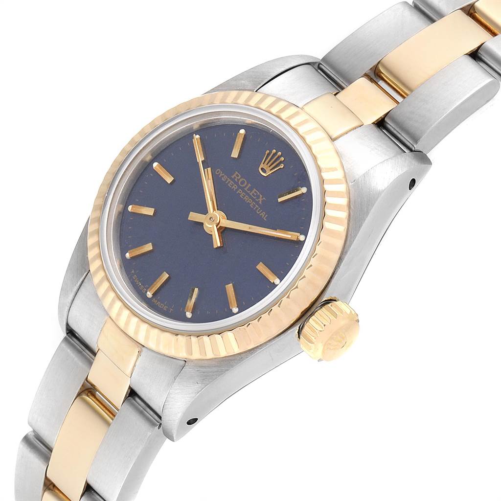 The image shows a close-up angled view of the Rolex Oyster Perpetual 67193 Women's Steel and Gold (two tone) Blue Dial 67193 Women's Steel and Gold (two tone) Blue Dial watch, focusing on the face, bezel, crown, and part of the bracelet.