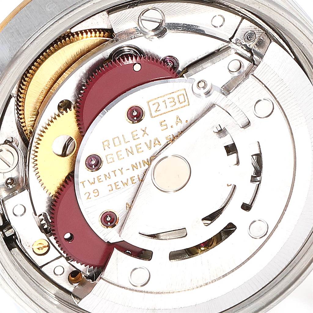 This image shows a detailed close-up of the movement mechanism of the Rolex Oyster Perpetual 67193 Women's Steel and Gold (two tone) White Dial 67193 Women's Steel and Gold (two tone) White Dial watch.