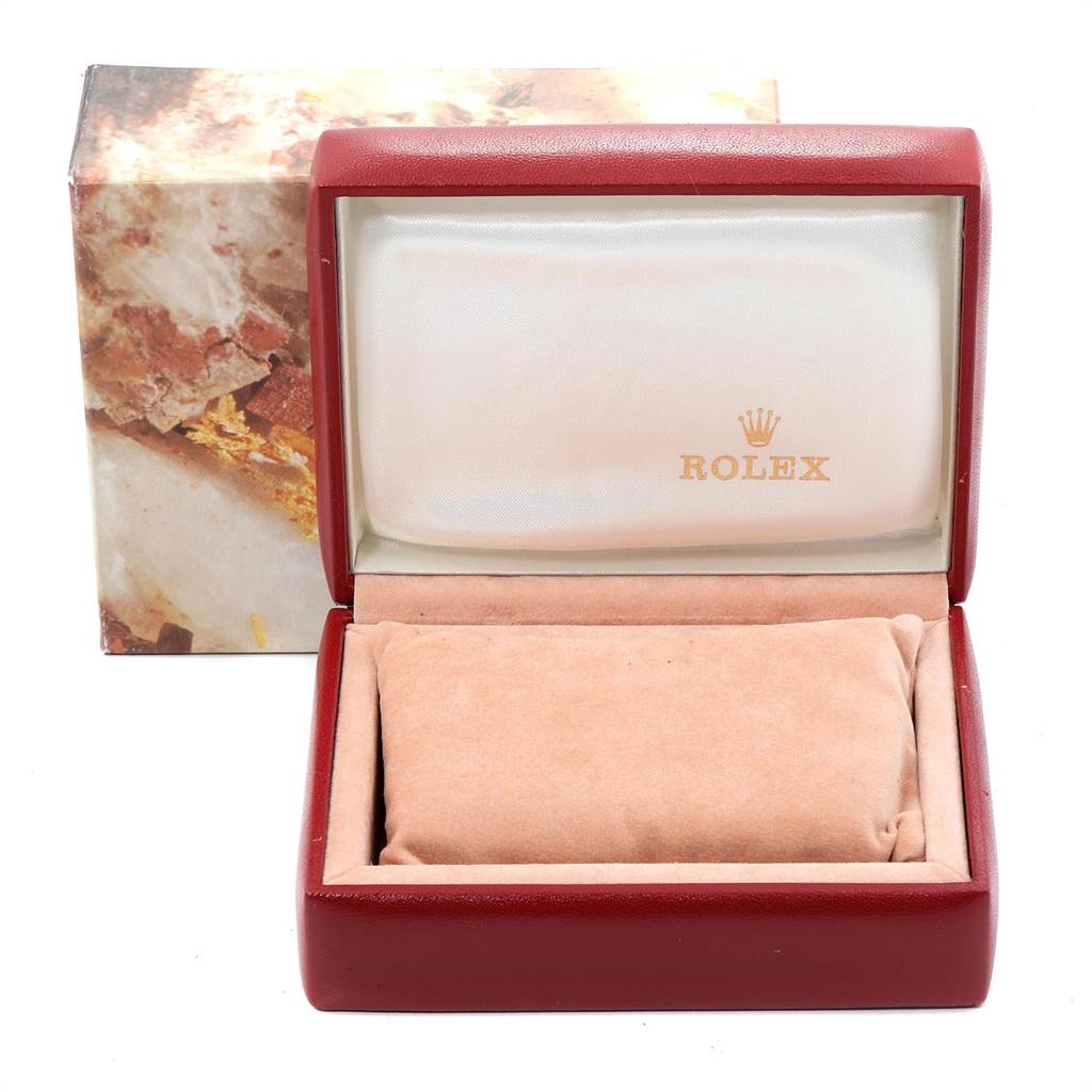 This image shows an open Rolex Oyster Perpetual 67193 Women's Steel and Gold (two tone) White Dial 67193 Women's Steel and Gold (two tone) White Dial watch box with a cushion, angled from the front.