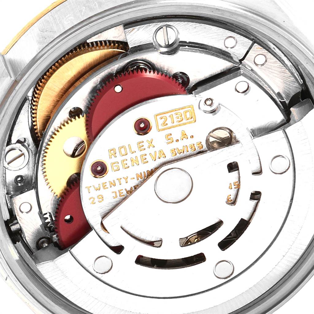 The image shows a detailed view of the Rolex Oyster Perpetual 67193 Women's Steel and Gold (two tone) White Dial 67193 Women's Steel and Gold (two tone) White Dial watch's internal movement mechanism.