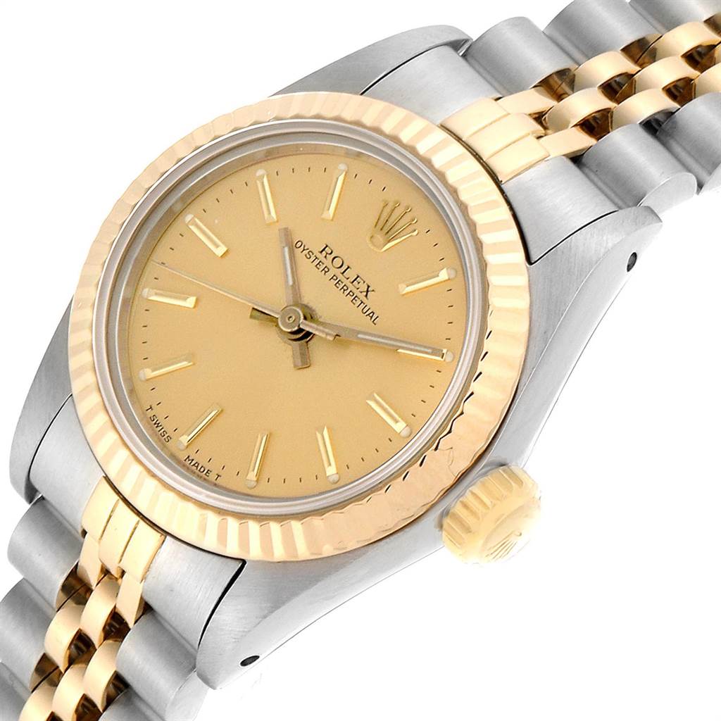 This image shows a close-up view of a Rolex Oyster Perpetual 67193 Women's Steel and Gold (two tone) Champagne Dial 67193 Women's Steel and Gold (two tone) Champagne Dial watch, showcasing its gold and silver bezel, dial, and bracelet.