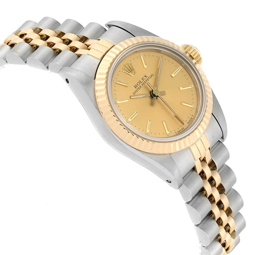 The image shows a side angle of a Rolex Oyster Perpetual 67193 Women's Steel and Gold (two tone) Champagne Dial 67193 Women's Steel and Gold (two tone) Champagne Dial watch highlighting the yellow gold bezel, champagne dial, and two-tone bracelet.