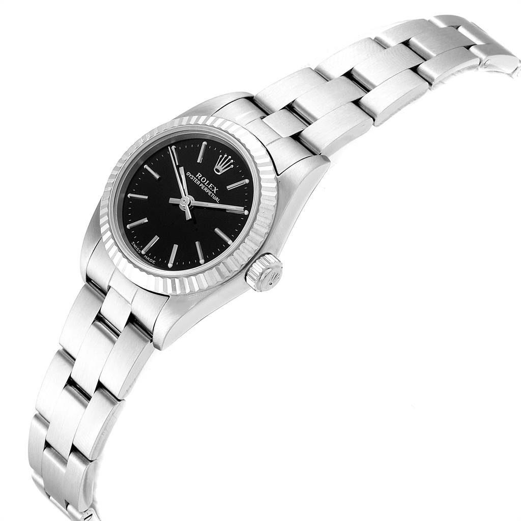 The image shows a side angle of a Rolex Oyster Perpetual 76094 Women's Stainless Steel Black Dial 76094 Women's Stainless Steel Black Dial watch, highlighting the black dial, bezel, crown, and metal bracelet.