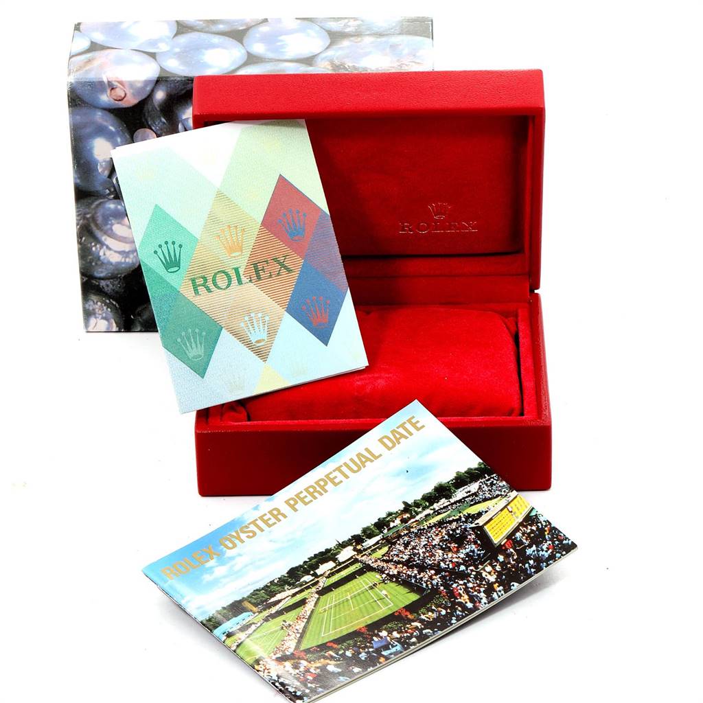 This image shows a Rolex Oyster Perpetual 76094 Women's Stainless Steel Black Dial 76094 Women's Stainless Steel Black Dial model's box with accompanying booklets in an open, side-facing angle.