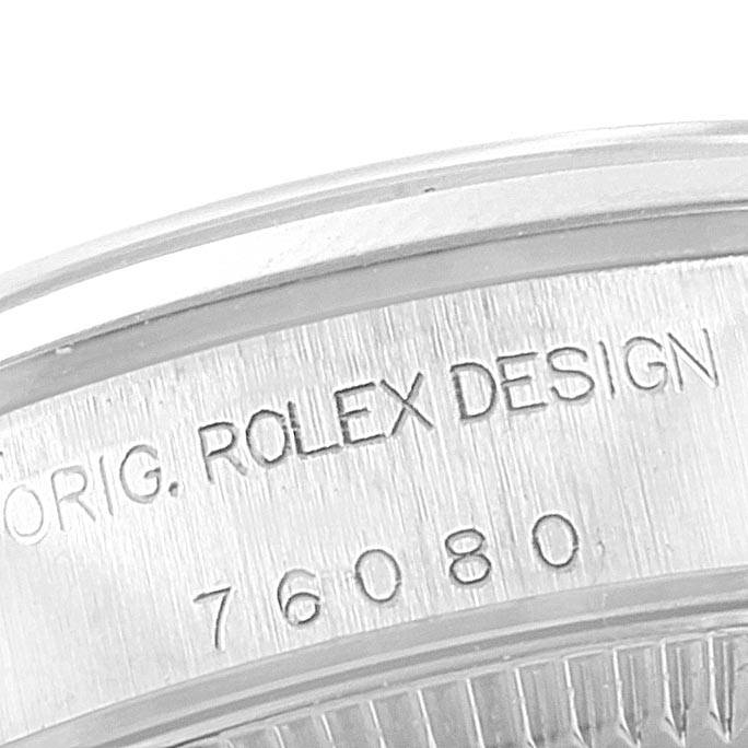 The image shows a close-up of the case back of a Rolex Oyster Perpetual 76094 Women's Stainless Steel Black Dial 76094 Women's Stainless Steel Black Dial watch, highlighting the engraved model number and "ROLEX DESIGN."