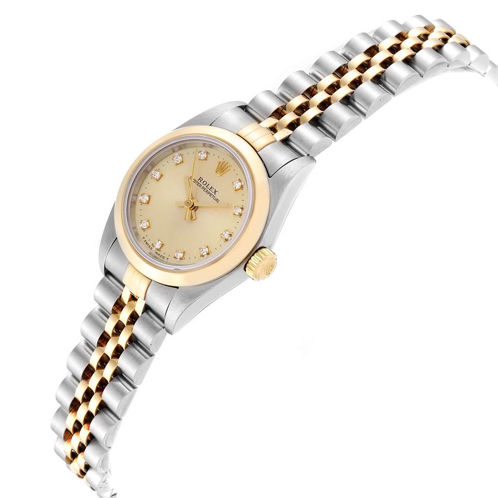 This Rolex Oyster Perpetual 76183 Women's Steel and Gold (two tone) Champagne Dial 76183 Women's Steel and Gold (two tone) Champagne Dial watch is shown at a slight angle, highlighting its gold and silver bracelet, face, and crown.