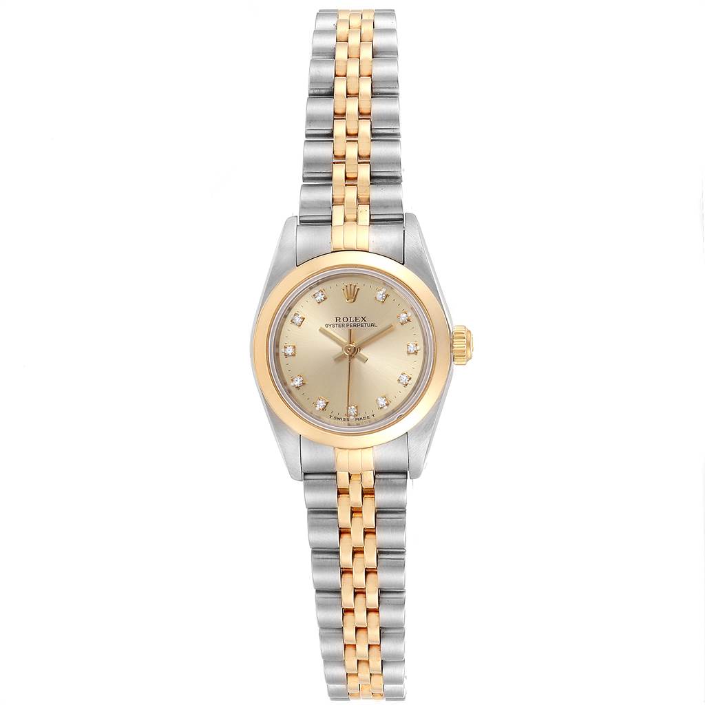 The image shows a Rolex Oyster Perpetual 76183 Women's Steel and Gold (two tone) Champagne Dial 76183 Women's Steel and Gold (two tone) Champagne Dial watch from a top view, showcasing its dial, case, bezel, and two-tone bracelet.