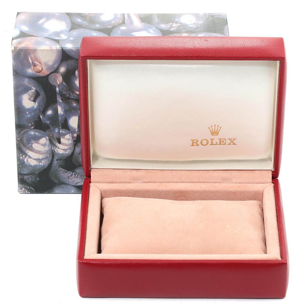 The image shows an empty, open Rolex Oyster Perpetual 67193 Women's Steel and Gold (two tone) Champagne Dial 67193 Women's Steel and Gold (two tone) Champagne Dial watch box with a red exterior and a cushion inside.