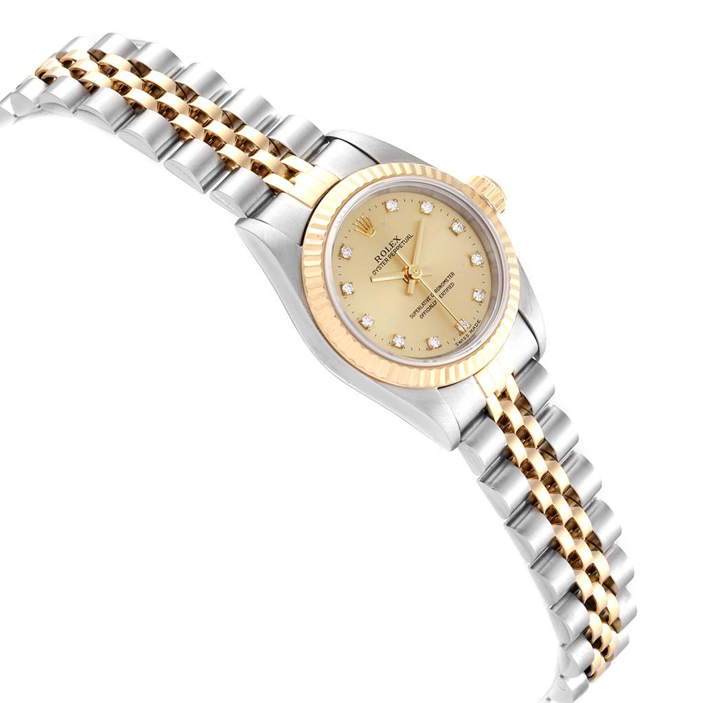The image shows a Rolex Oyster Perpetual 67193 Women's Steel and Gold (two tone) Champagne Dial 67193 Women's Steel and Gold (two tone) Champagne Dial watch from an angled side view, displaying its gold and silver bracelet and face.