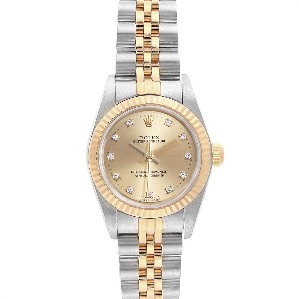 This image shows a Rolex Oyster Perpetual 67193 Women's Steel and Gold (two tone) Champagne Dial 67193 Women's Steel and Gold (two tone) Champagne Dial watch from a top-down angle, featuring a gold and silver bracelet and a gold dial with diamond markers.