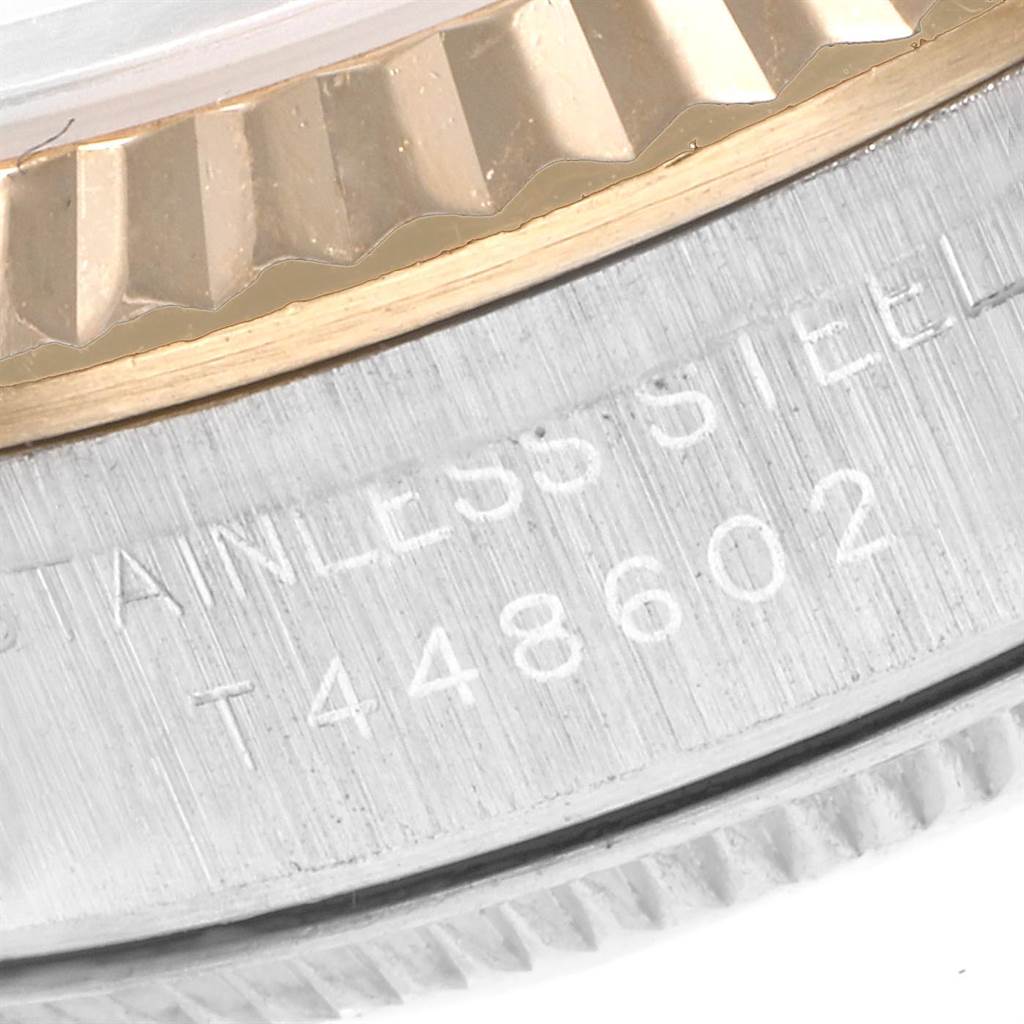 The zoomed-in image shows the side view of the Rolex Oyster Perpetual 67193 Women's Steel and Gold (two tone) Champagne Dial 67193 Women's Steel and Gold (two tone) Champagne Dial watch's case and bezel with the serial number engraved.