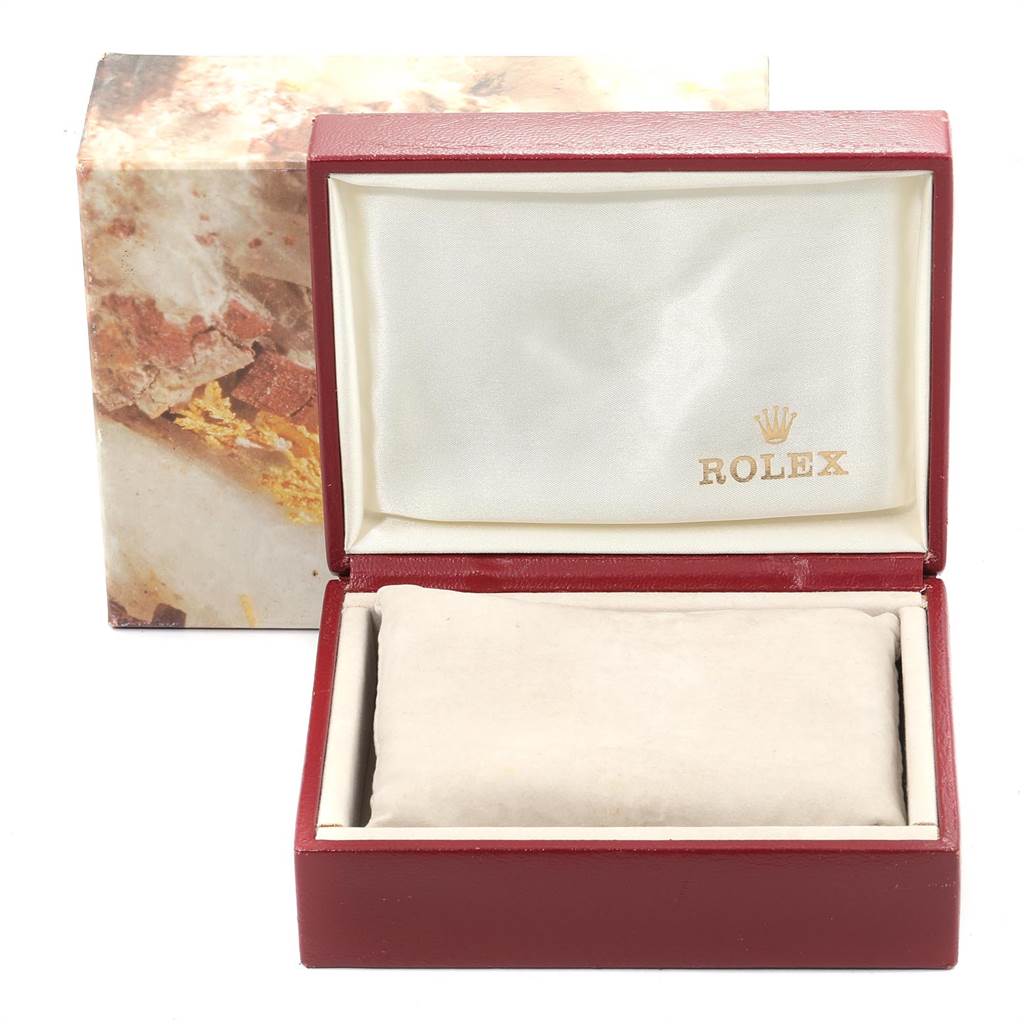 The image shows an open box for the Rolex Oyster Perpetual 76183 Women
s Steel and Gold (two tone) Champagne Dial 76183 Women
s Steel and Gold (two tone) Champagne Dial model, displaying the inside cushion and protective fabric.