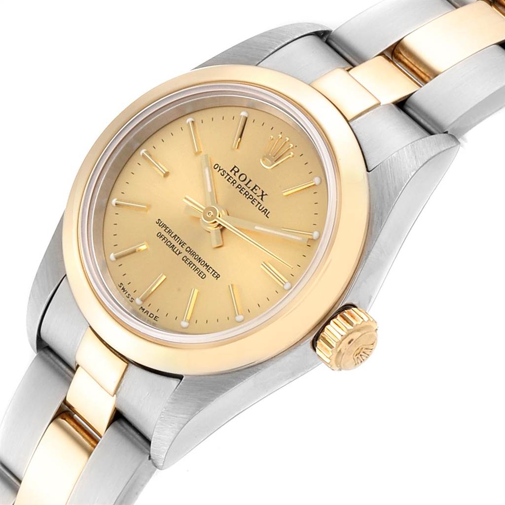 This image shows a close-up of the Rolex Oyster Perpetual 76183 Women
s Steel and Gold (two tone) Champagne Dial 76183 Women
s Steel and Gold (two tone) Champagne Dial watch, highlighting the dial, crown, and part of the two-tone bracelet.