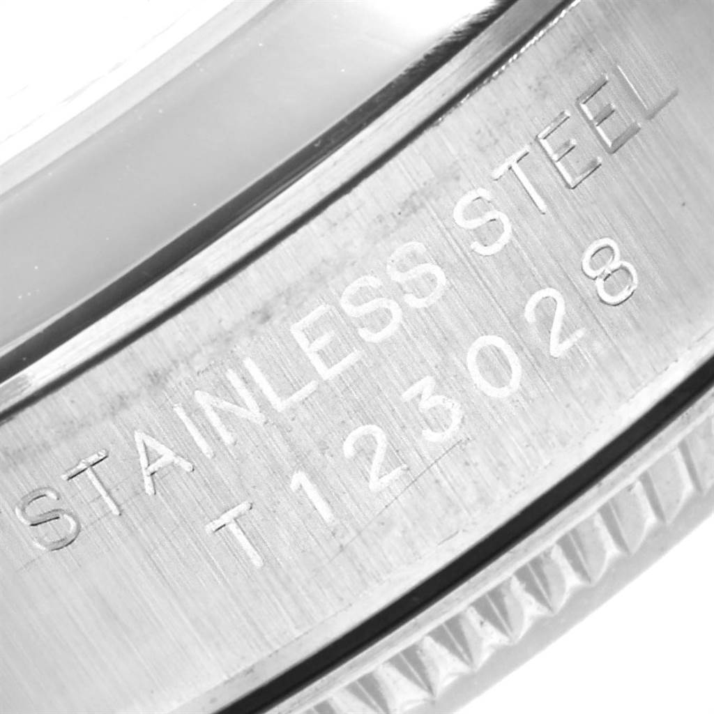 The image shows a close-up of the side casing of a Rolex Oyster Perpetual 67180 Women's Stainless Steel Pink Dial 67180 Women's Stainless Steel Pink Dial model, highlighting the "STAINLESS STEEL" engraving.