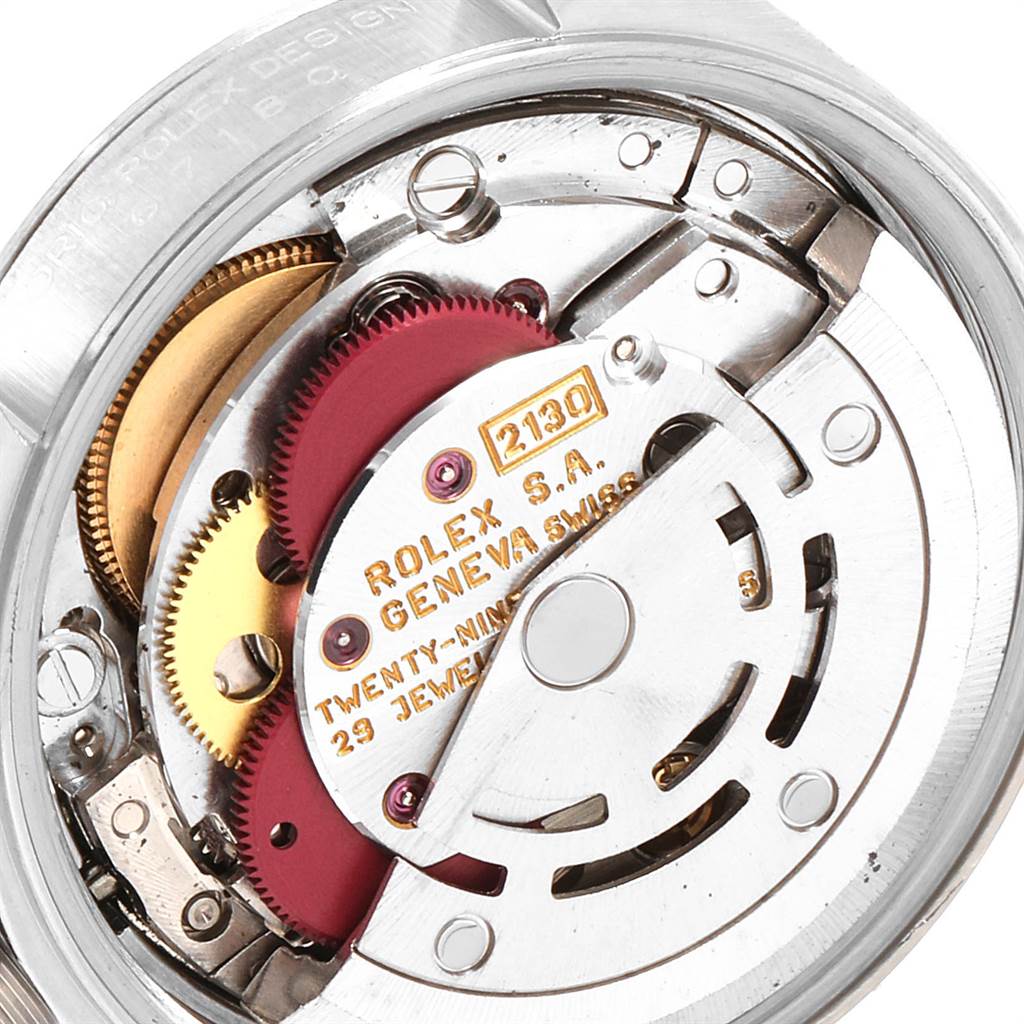 This image shows a close-up of the movement mechanism inside the Rolex Oyster Perpetual 67180 Women's Stainless Steel Pink Dial 67180 Women's Stainless Steel Pink Dial watch.