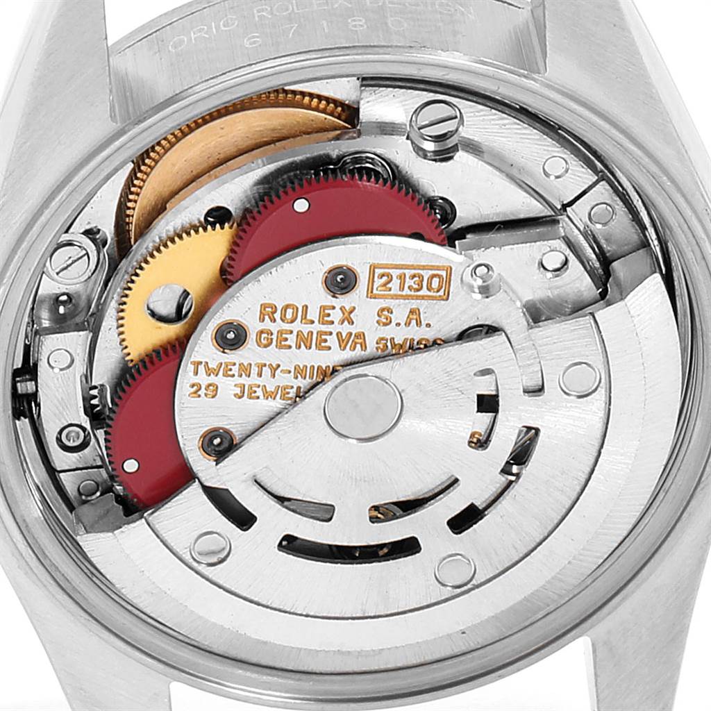 The image shows a close-up of the movement mechanism of a Rolex Oyster Perpetual 67180 Women's Stainless Steel Blue Dial 67180 Women's Stainless Steel Blue Dial watch, highlighting the intricate internal parts.