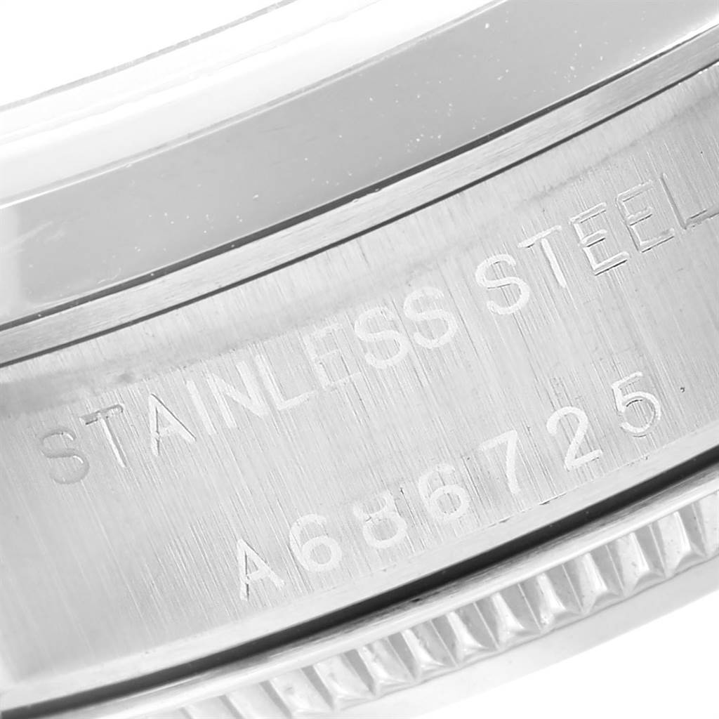 This image shows a close-up of the stainless steel casing and serial number of a Rolex Oyster Perpetual 76080 Women's Stainless Steel Pink Dial 76080 Women's Stainless Steel Pink Dial watch.