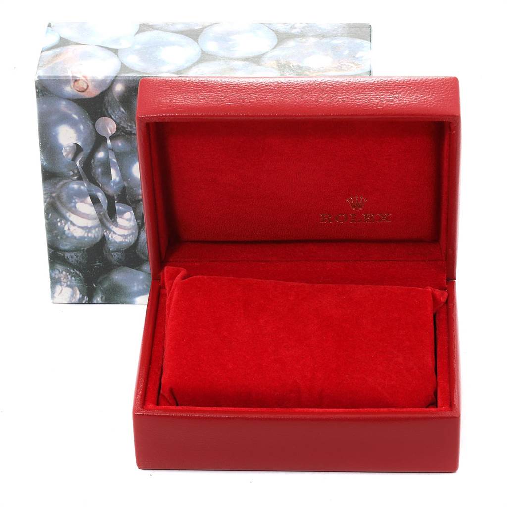 The image shows an empty red Rolex watch box for the Oyster Perpetual model, with the outer packaging in the background.