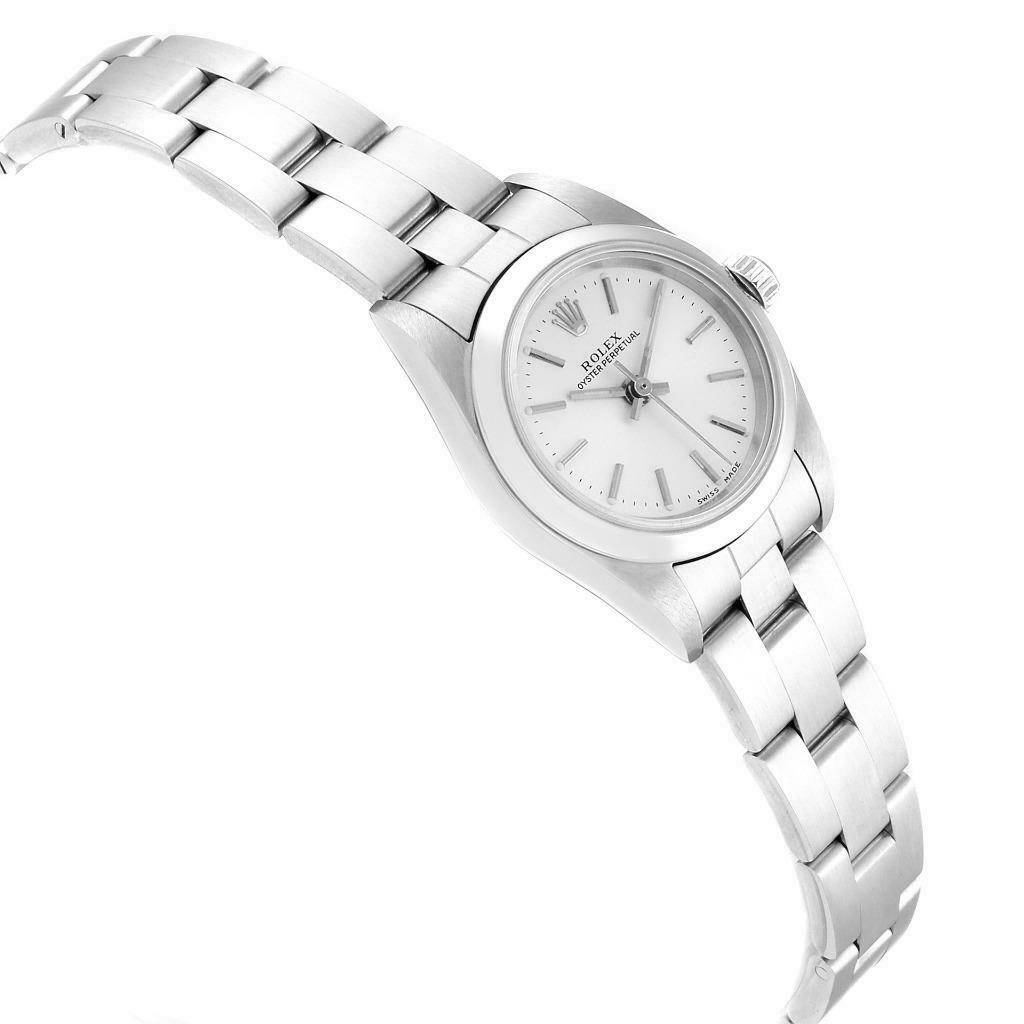 The Rolex Oyster Perpetual 76080 Women's Stainless Steel Silver Dial 76080 Women's Stainless Steel Silver Dial watch is shown at an angle highlighting the face, bezel, and a significant portion of its metal bracelet.
