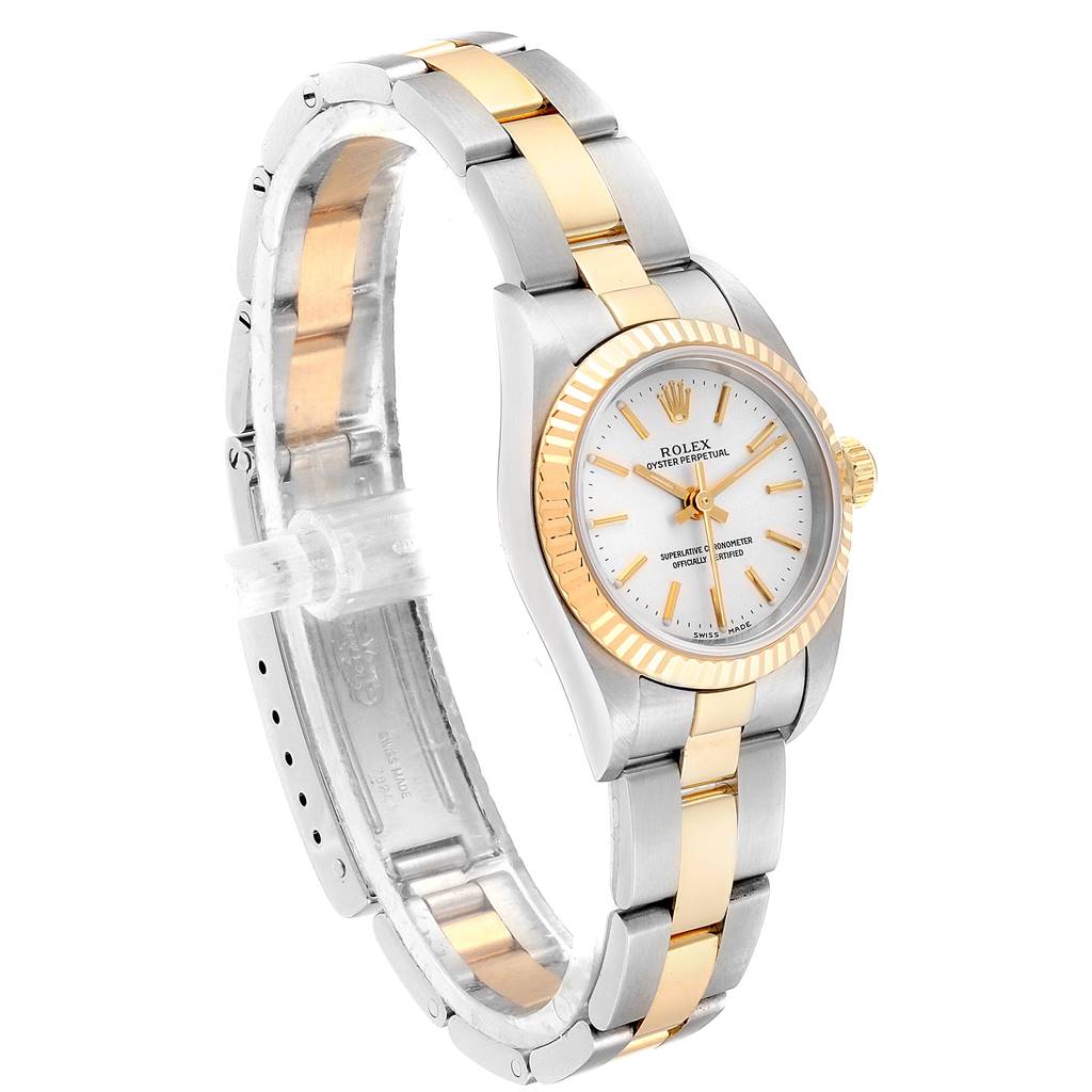 The Rolex Oyster Perpetual 76193 Women's Steel and Gold (two tone) Silver Dial 76193 Women's Steel and Gold (two tone) Silver Dial watch is shown at a side angle, displaying its two-tone band, white dial, and fluted bezel.