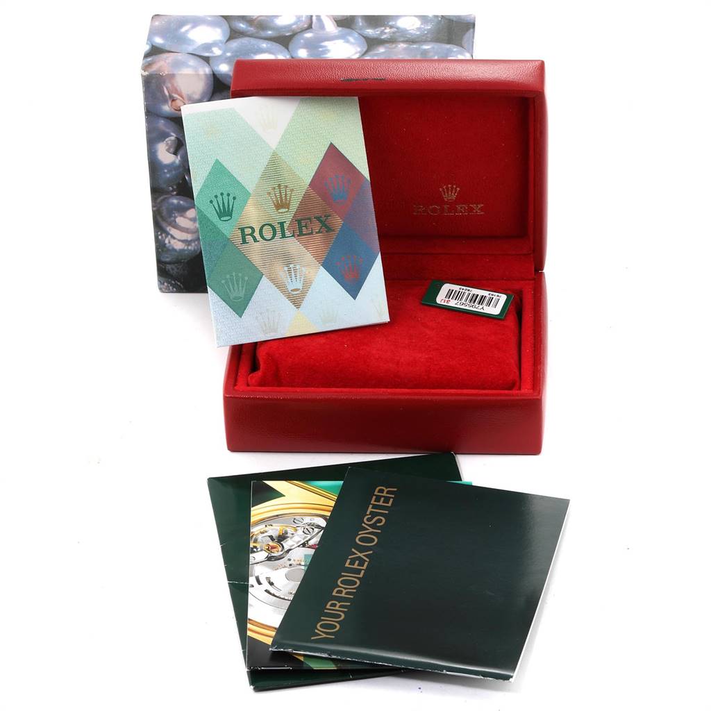 This image shows the open box of a Rolex Oyster Perpetual 76193 Women's Steel and Gold (two tone) Silver Dial 76193 Women's Steel and Gold (two tone) Silver Dial watch along with its booklet, warranty card, and packaging materials.