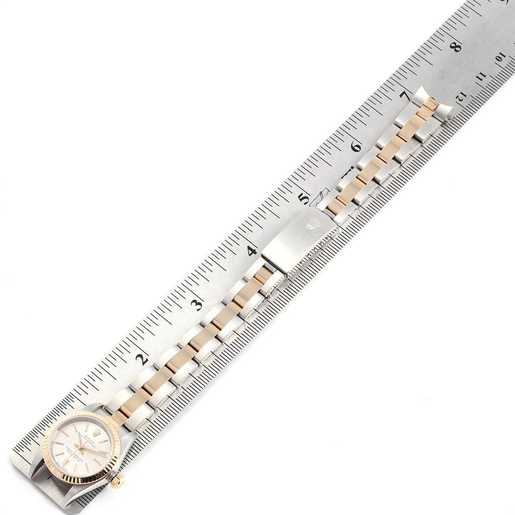 This image shows a top-down view of a Rolex Oyster Perpetual 76193 Women's Steel and Gold (two tone) Silver Dial 76193 Women's Steel and Gold (two tone) Silver Dial watch and bracelet, aligned with a measuring ruler.