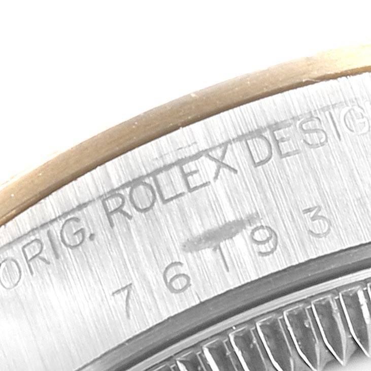 The image shows a close-up of the case side, displaying the engraved "ORIG. ROLEX DESIGN" on the Oyster Perpetual model by Rolex.