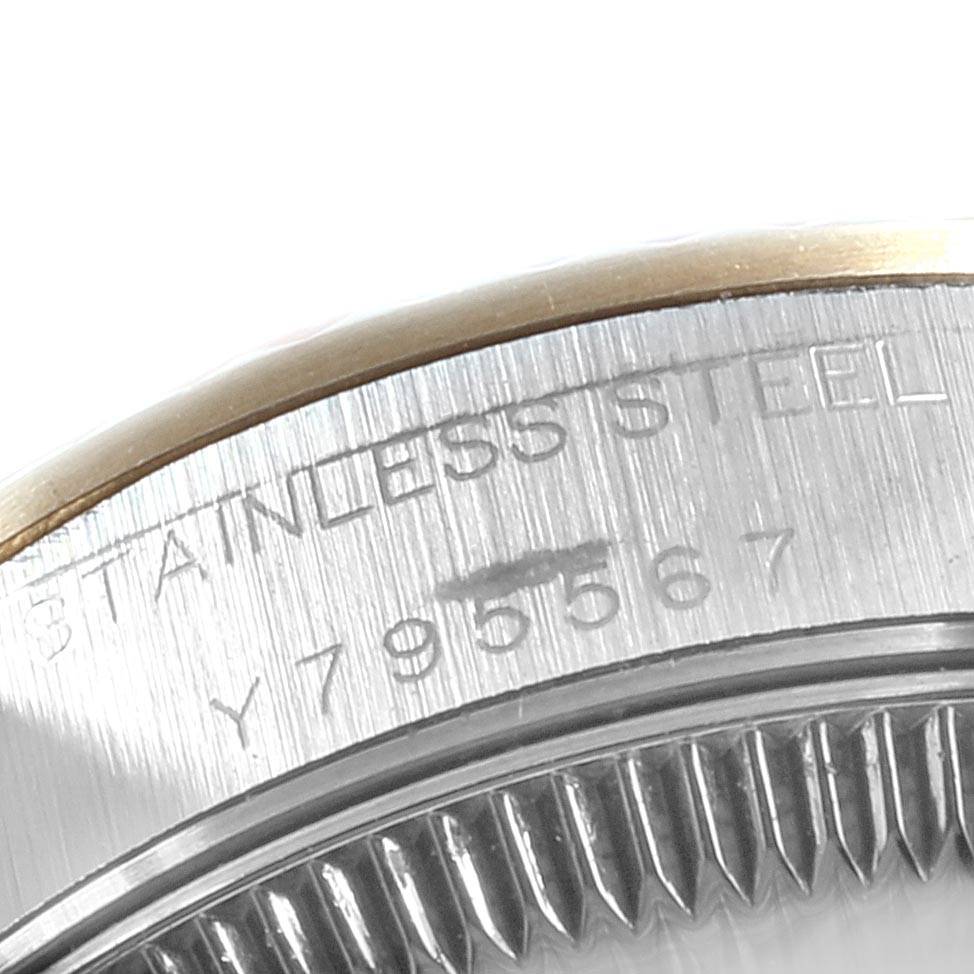 This close-up image shows the engraved stainless steel part of a Rolex Oyster Perpetual 76193 Women's Steel and Gold (two tone) Silver Dial 76193 Women's Steel and Gold (two tone) Silver Dial watch.