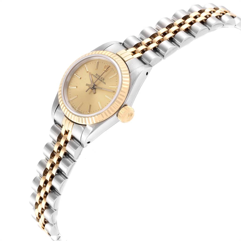 The image shows a side angle of a Rolex Oyster Perpetual 67193 Women's Steel and Gold (two tone) Champagne Dial 67193 Women's Steel and Gold (two tone) Champagne Dial watch, featuring its bezel, crown, and part of the bracelet.