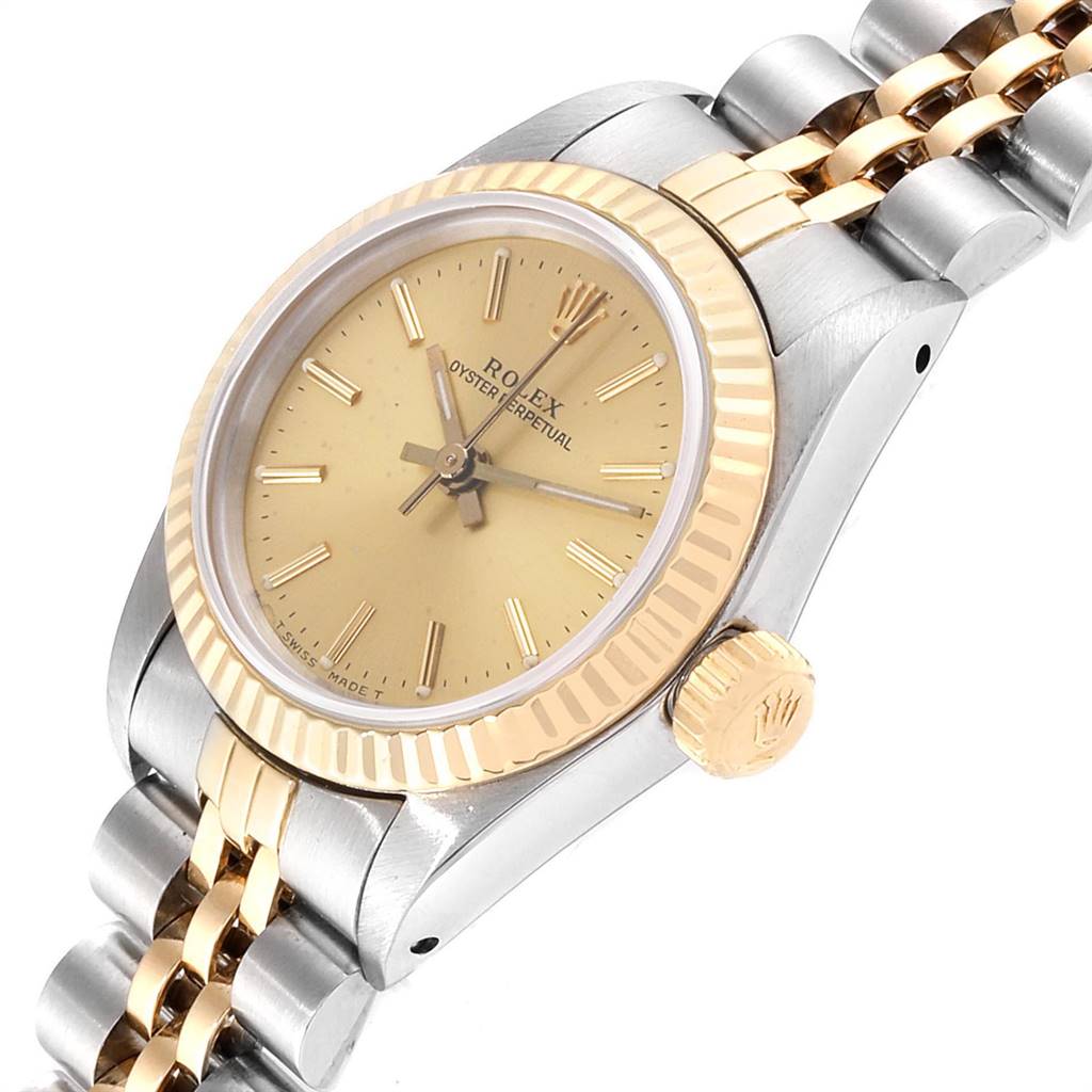 This image shows a Rolex Oyster Perpetual 67193 Women's Steel and Gold (two tone) Champagne Dial 67193 Women's Steel and Gold (two tone) Champagne Dial watch viewed at an angle, highlighting its bezel, dial, crown, and part of the bracelet.