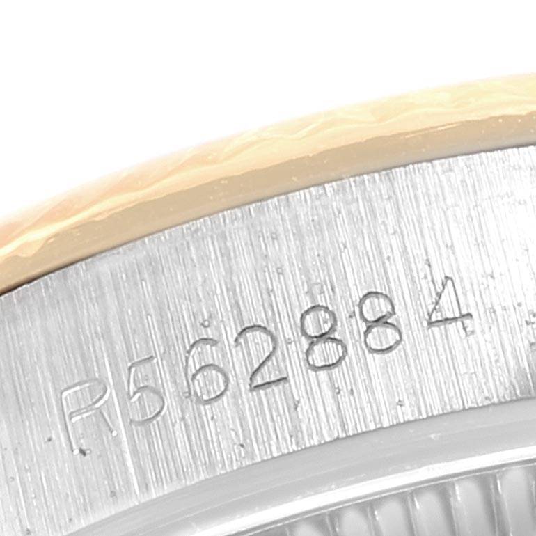 The image shows a close-up of the serial number engraving on the side of a Rolex Oyster Perpetual 67193 Women's Steel and Gold (two tone) Champagne Dial 67193 Women's Steel and Gold (two tone) Champagne Dial watch case.