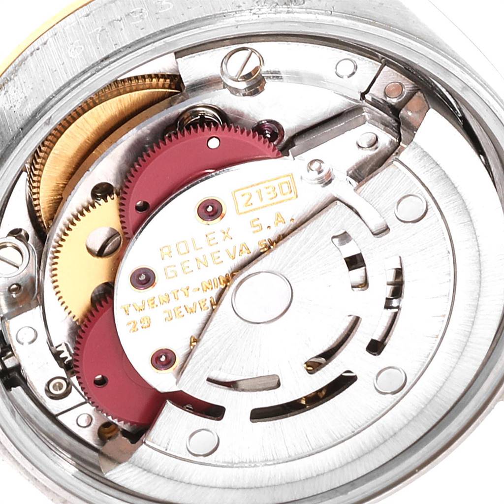This close-up view shows the internal mechanism of the Oyster Perpetual model by Rolex, including gears and jewels.