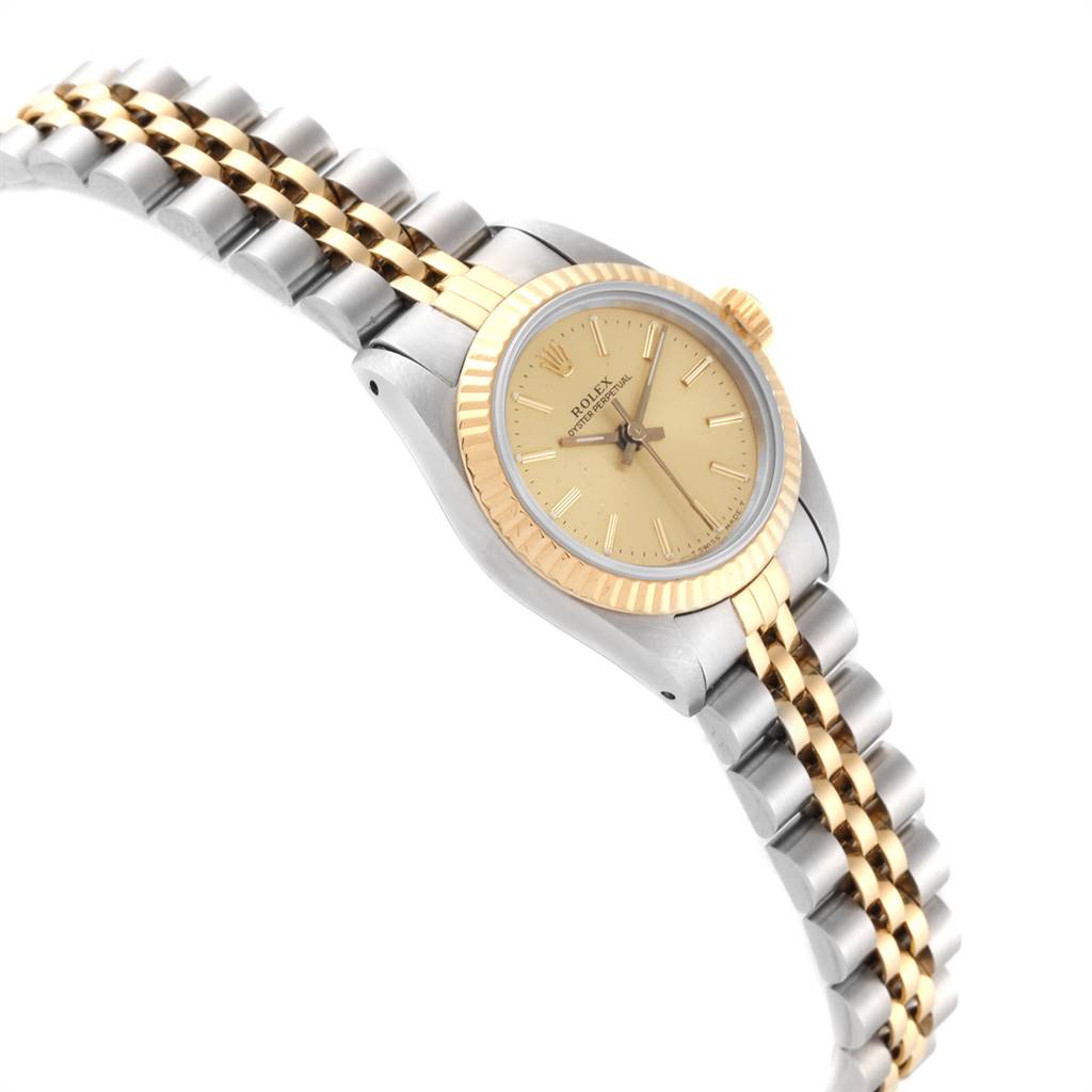 The image shows a Rolex Oyster Perpetual 67193 Women's Steel and Gold (two tone) Champagne Dial 67193 Women's Steel and Gold (two tone) Champagne Dial watch at an angle, highlighting its gold bezel, dial, and two-tone metal bracelet.