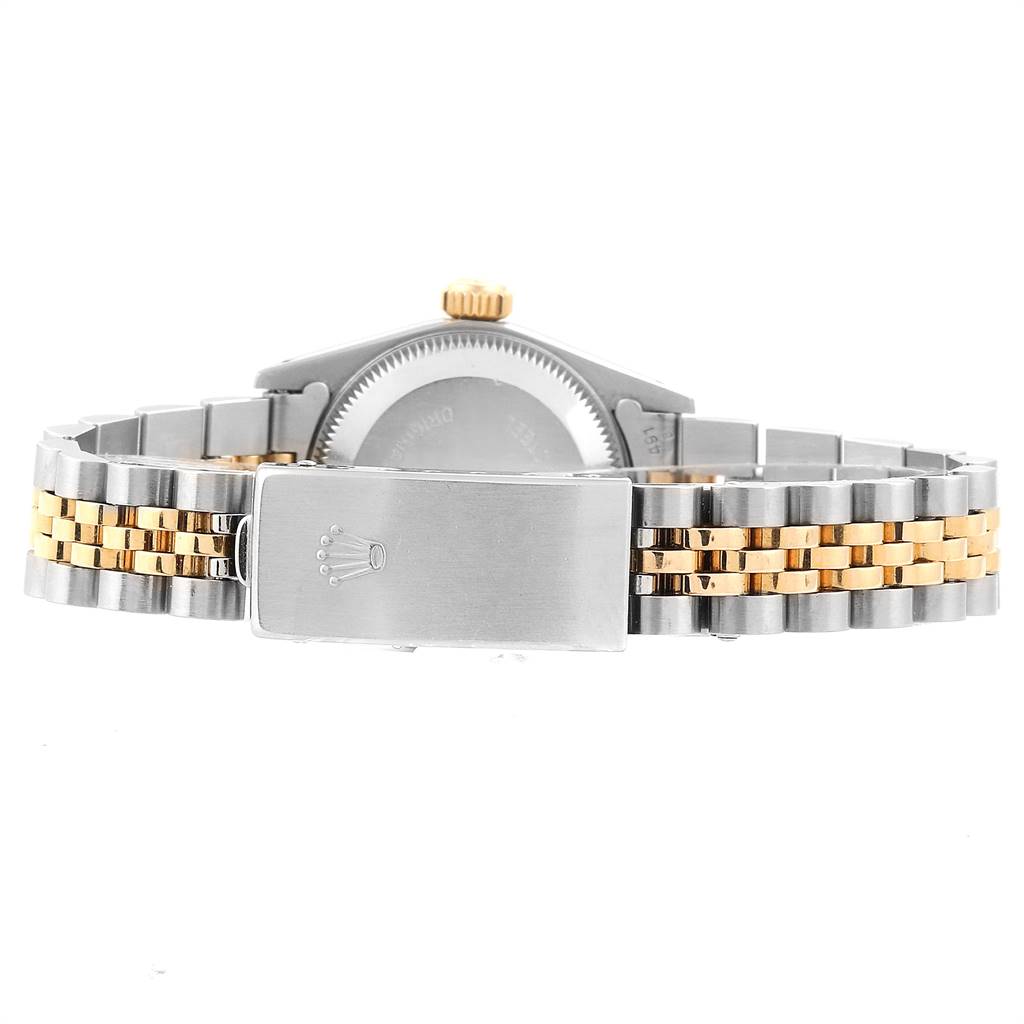 The image shows the back view of a Rolex Oyster Perpetual 67193 Women's Steel and Gold (two tone) Champagne Dial 67193 Women's Steel and Gold (two tone) Champagne Dial watch, focusing on the bracelet and clasp with the branded logo.