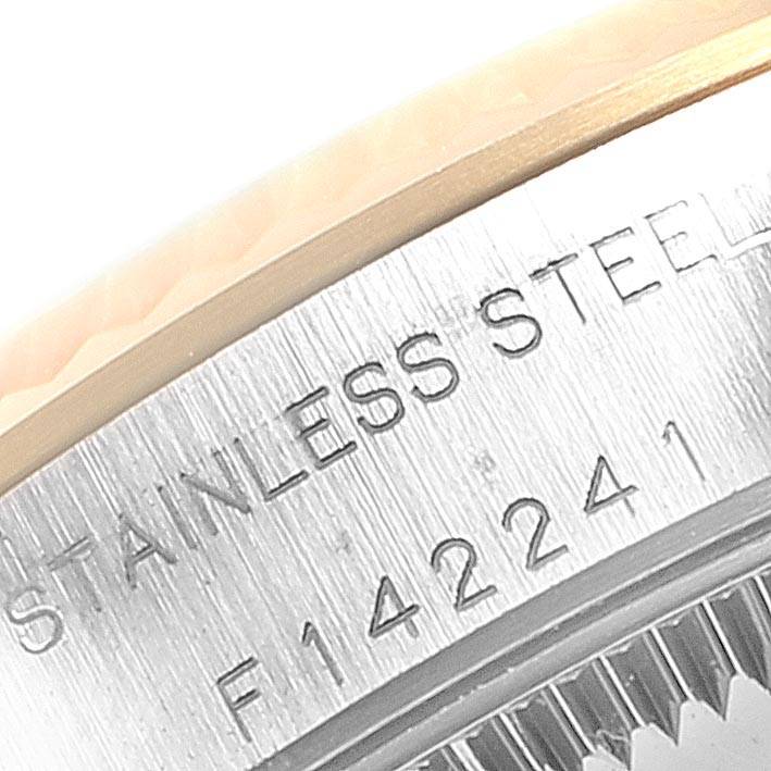 This close-up image shows part of the case back of the Rolex Oyster Perpetual 76193 Women's Steel and Gold (two tone) Silver Dial 76193 Women's Steel and Gold (two tone) Silver Dial, highlighting "STAINLESS STEEL" and a serial number.