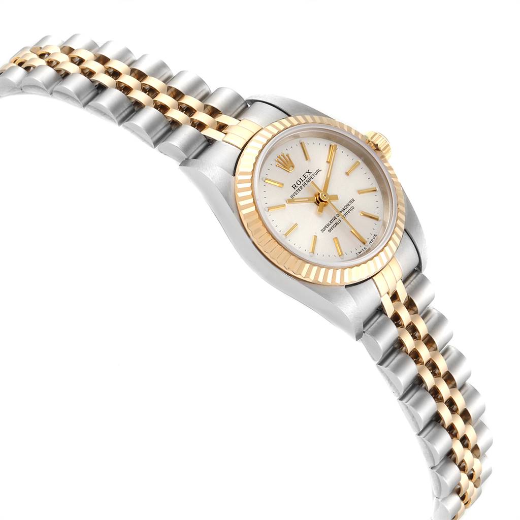 The image shows an angled view of a Rolex Oyster Perpetual 76193 Women's Steel and Gold (two tone) Silver Dial 76193 Women's Steel and Gold (two tone) Silver Dial watch, highlighting the face, bezel, and bracelet.