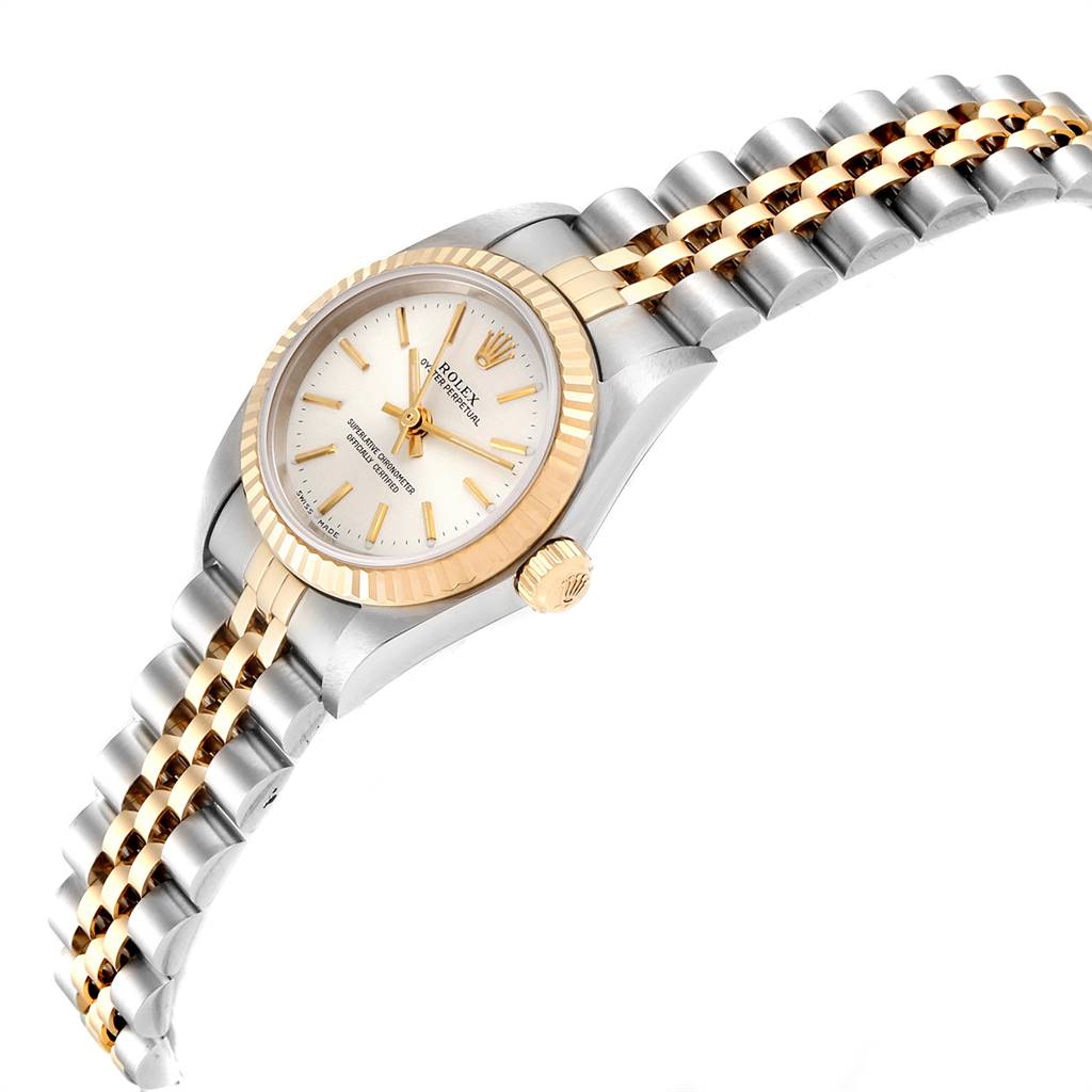 The Rolex Oyster Perpetual 76193 Women's Steel and Gold (two tone) Silver Dial 76193 Women's Steel and Gold (two tone) Silver Dial watch is shown at a side angle, highlighting its two-tone band, crown, and face.