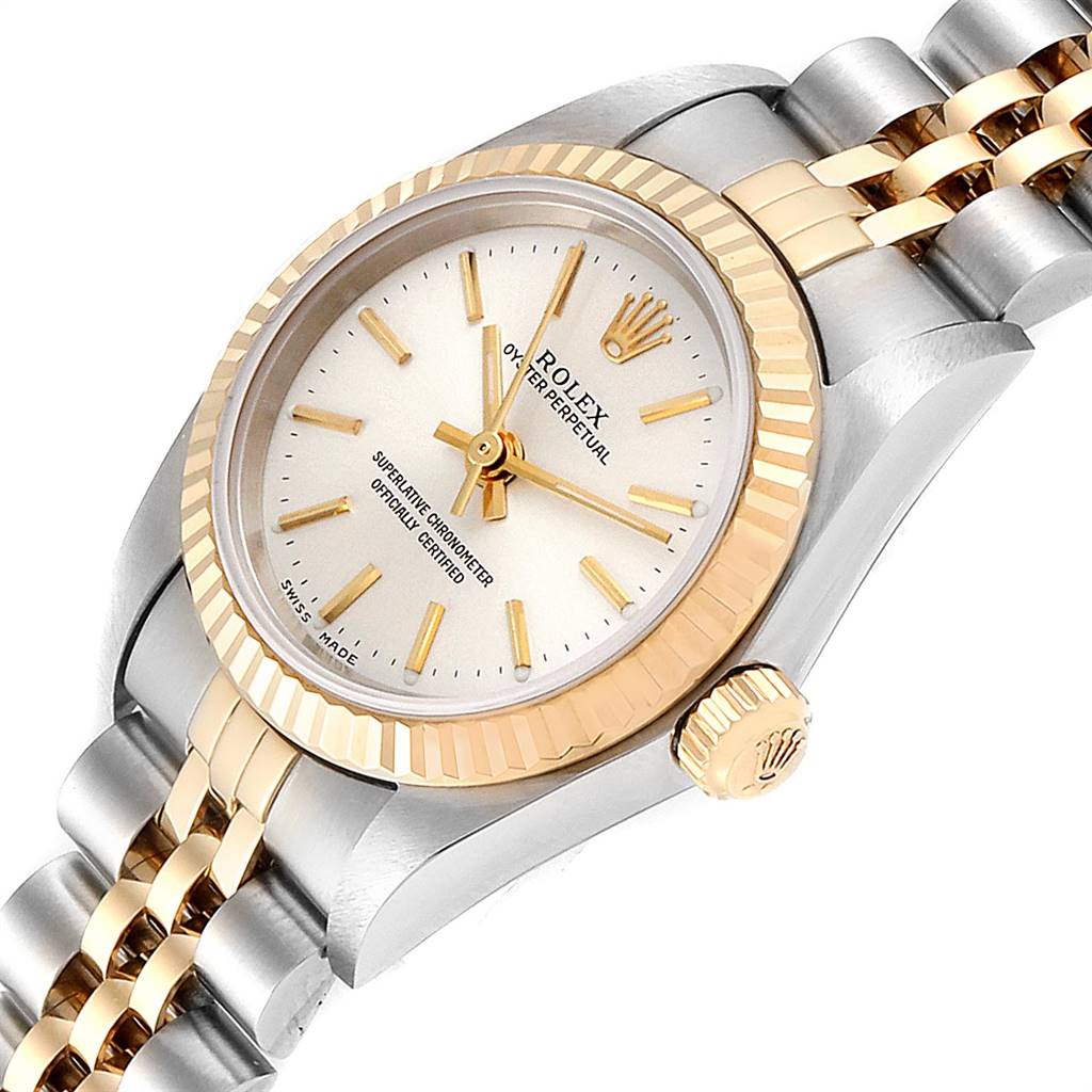 This image shows a close-up angled view of a Rolex Oyster Perpetual 76193 Women's Steel and Gold (two tone) Silver Dial 76193 Women's Steel and Gold (two tone) Silver Dial watch, highlighting its dial, bezel, crown, and bracelet.