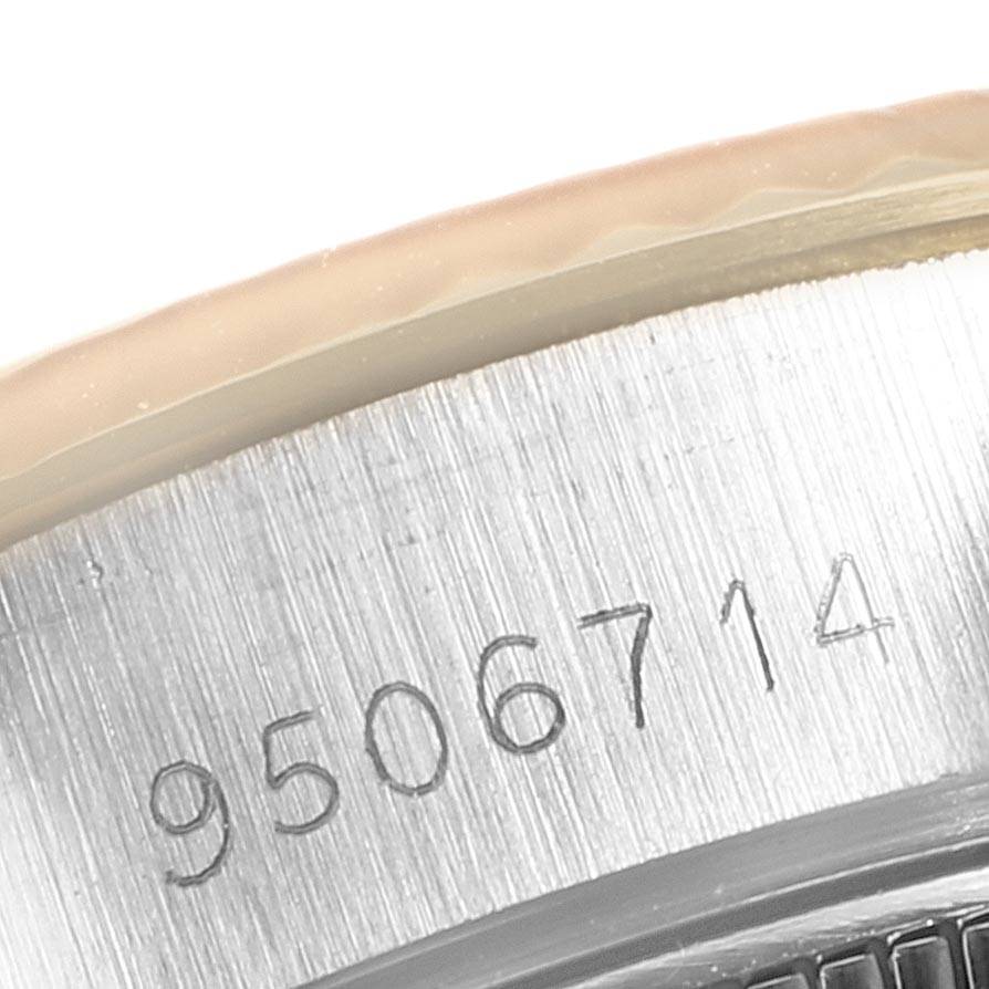 This close-up image shows the serial number engraved on the side of the case of a Rolex Oyster Perpetual 69173 Women's Stainless Steel Champagne Dial 69173 Women's Stainless Steel Champagne Dial watch.