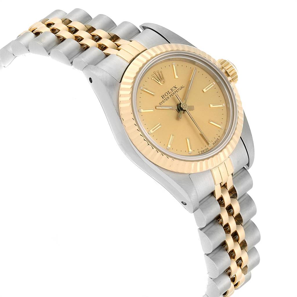 The image shows a Rolex Oyster Perpetual 67193 Women
s Steel and Gold (two tone) Champagne Dial 67193 Women
s Steel and Gold (two tone) Champagne Dial watch at an angle, highlighting its gold and silver bracelet, bezel, and dial.