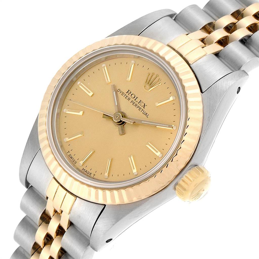 This Rolex Oyster Perpetual 67193 Women
s Steel and Gold (two tone) Champagne Dial 67193 Women
s Steel and Gold (two tone) Champagne Dial watch is shown at an angled view highlighting its golden dial, bezel, and two-tone bracelet.