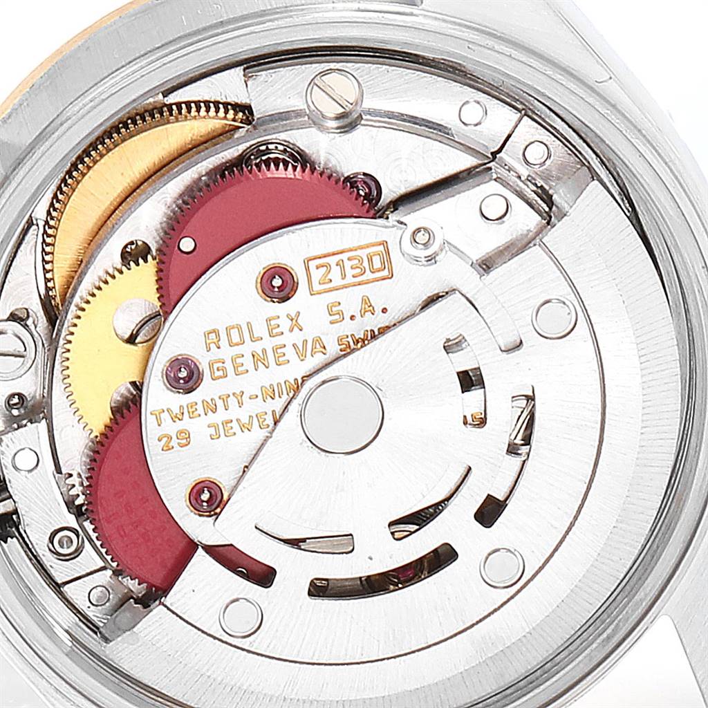 The image shows the intricate inner mechanism, specifically the movement, of a Rolex Oyster Perpetual 67193 Women
s Steel and Gold (two tone) Champagne Dial 67193 Women
s Steel and Gold (two tone) Champagne Dial watch.