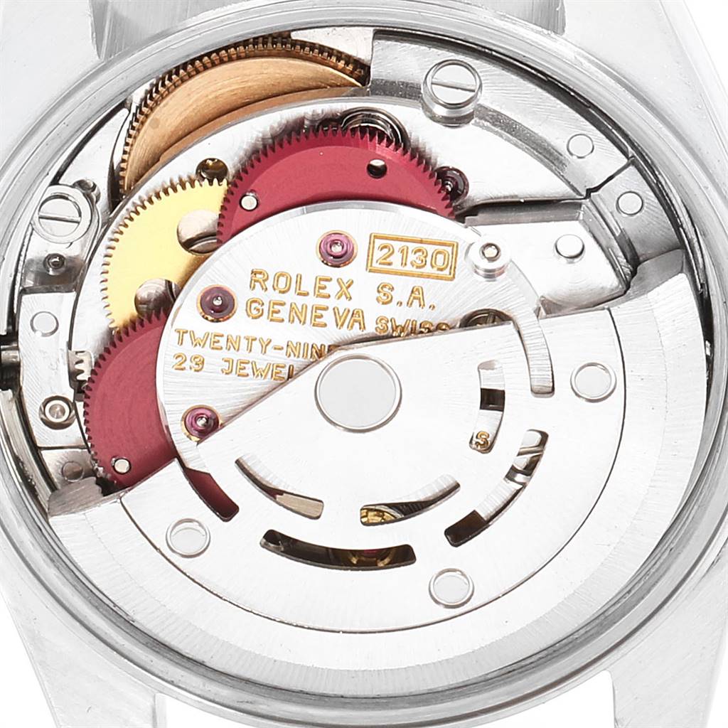 The image shows the internal mechanical movement of a Rolex Oyster Perpetual 67183 Women's Steel and Gold (two tone) Silver Dial 67183 Women's Steel and Gold (two tone) Silver Dial watch from a rear angle.
