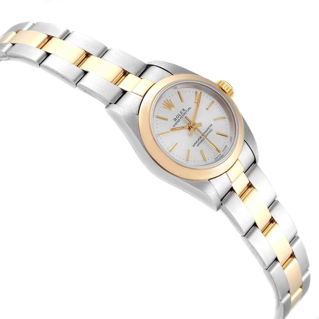 This image shows a two-tone Rolex Oyster Perpetual 67183 Women's Steel and Gold (two tone) Silver Dial 67183 Women's Steel and Gold (two tone) Silver Dial watch from a slight top-side angle, highlighting its bracelet and dial.