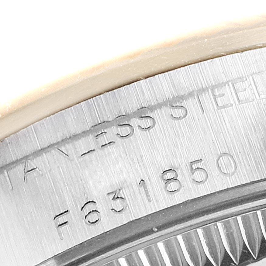 This image shows a close-up of the stainless steel bezel and serial engraving on the Rolex Oyster Perpetual 76193 Women
s Steel and Gold (two tone) Blue Dial 76193 Women
s Steel and Gold (two tone) Blue Dial watch.