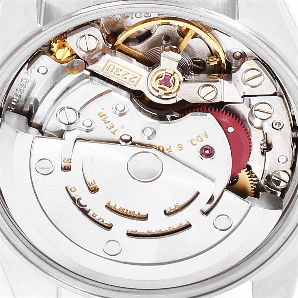The image shows a close-up view of the movement mechanism of a Rolex Oyster Perpetual 76193 Women
s Steel and Gold (two tone) Blue Dial 76193 Women
s Steel and Gold (two tone) Blue Dial watch.