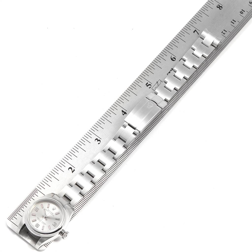 The image shows a Rolex Oyster Perpetual 176200 Women's Stainless Steel Silver Dial 176200 Women's Stainless Steel Silver Dial watch with its bracelet extended alongside a ruler for measurement.