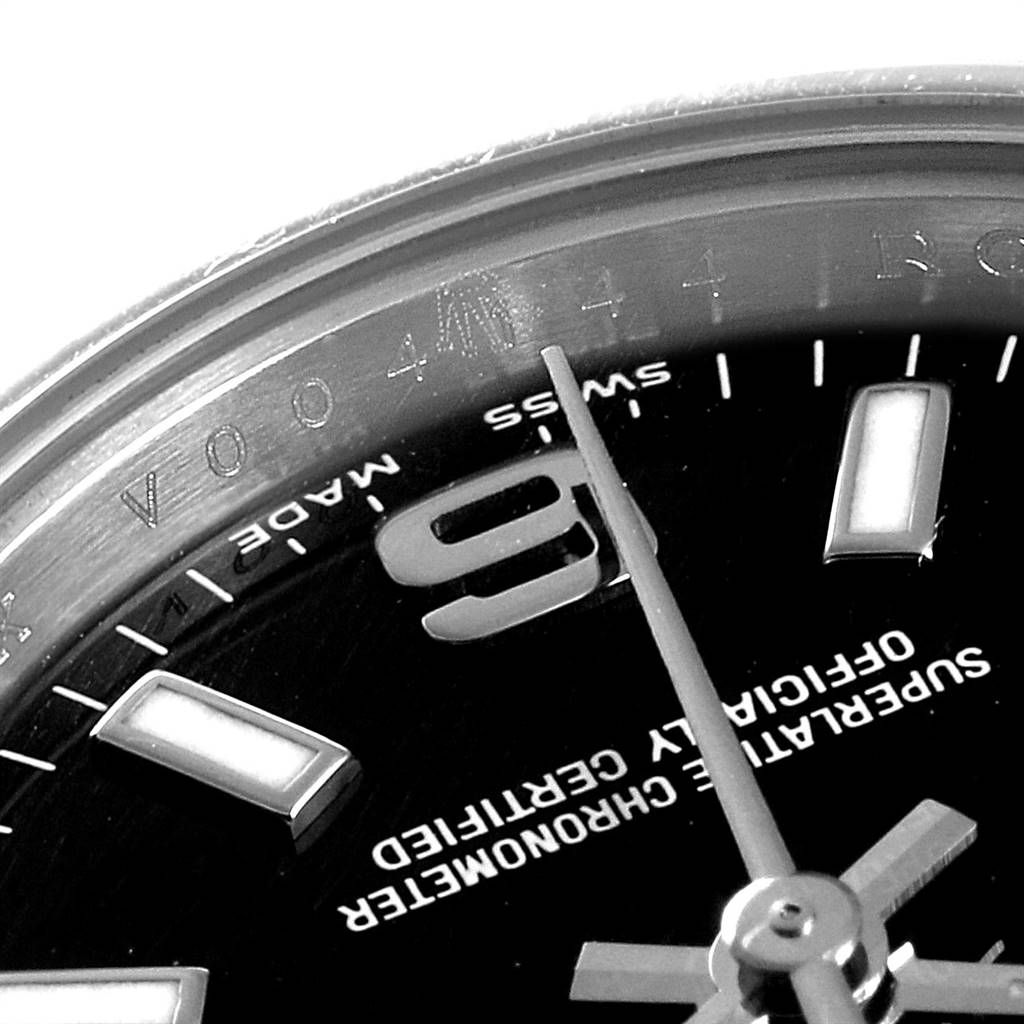 This close-up of the Rolex Oyster Perpetual 176200 Women
s Stainless Steel Black Dial 176200 Women
s Stainless Steel Black Dial watch shows part of the dial, hour markers, and hands.